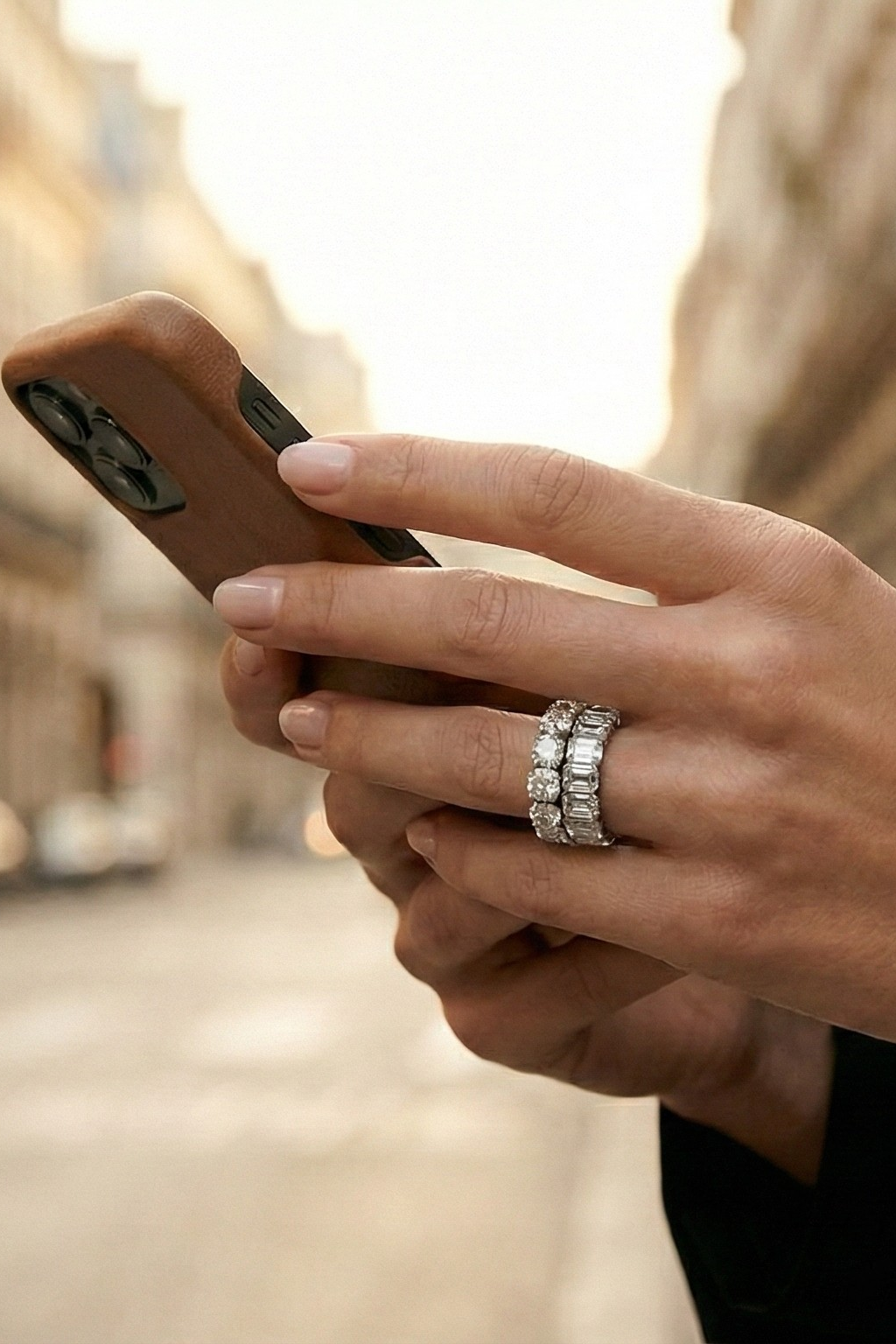 Person holding a smartphone with a blurred city street background