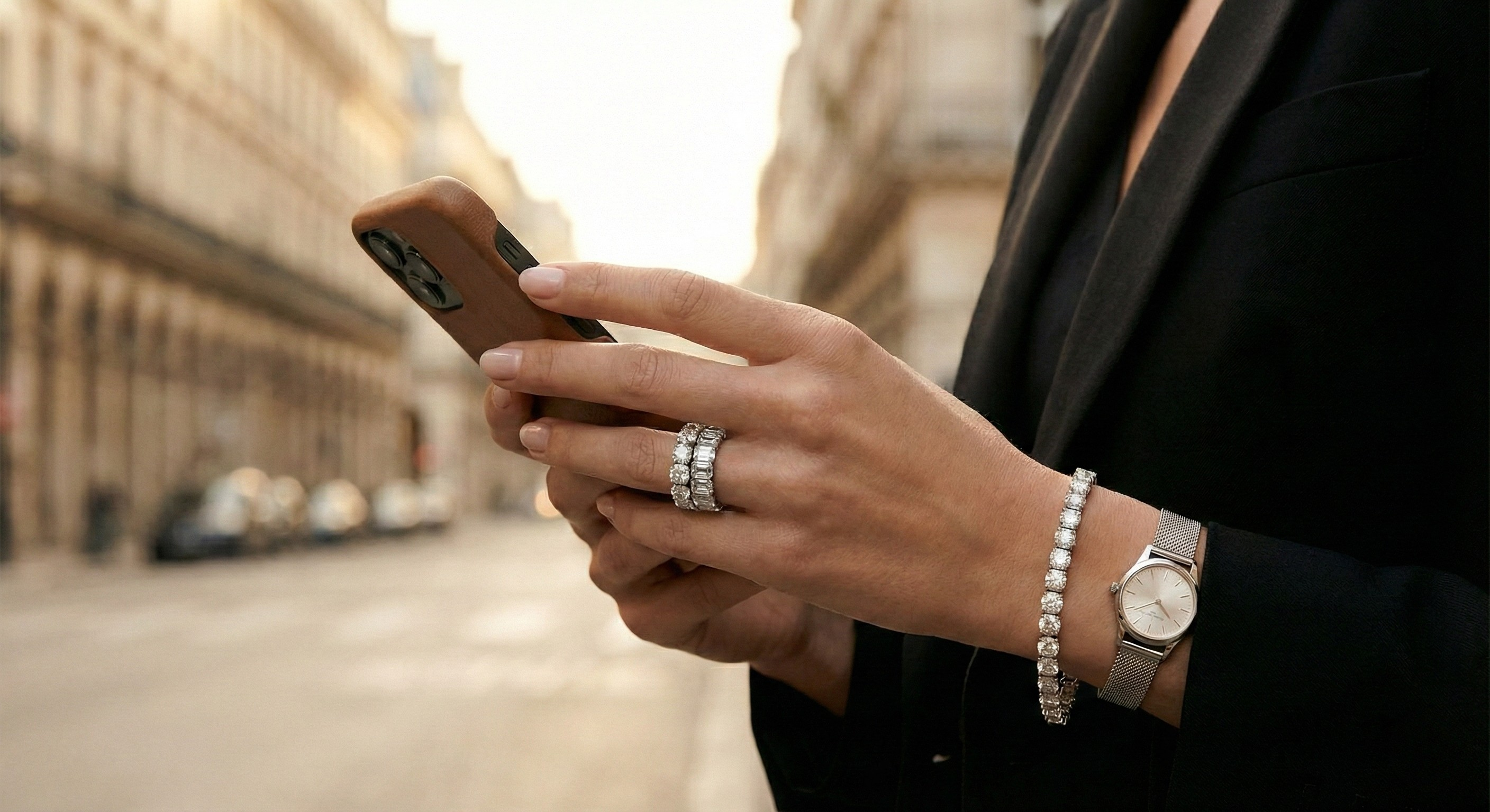 Person holding a smartphone with a blurred city street background