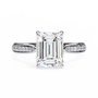ring features a magnificent Emerald-cut diamond held in a refined prong setting