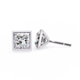 Two diamond stud earrings on a white background