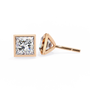 Two diamond stud earrings on a white background