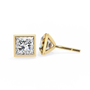 Pair of diamond stud earrings with gold prongs on a white background