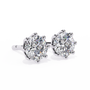 Pair of diamond stud earrings on a white background