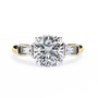 trilogy ring features a magnificent Cushion-cut solitaire flanked by two tapering baguette diamonds