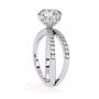 ring features a Round Brilliant solitaire supported by a sophisticated double band encrusted with Pavé diamonds