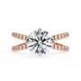 ring features a Round Brilliant solitaire supported by a sophisticated double band encrusted with Pavé diamonds