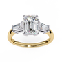 ring features a magnificent Emerald-cut centre flanked by two tapering baguette diamonds