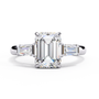 ring features a magnificent Emerald-cut centre flanked by two tapering baguette diamonds