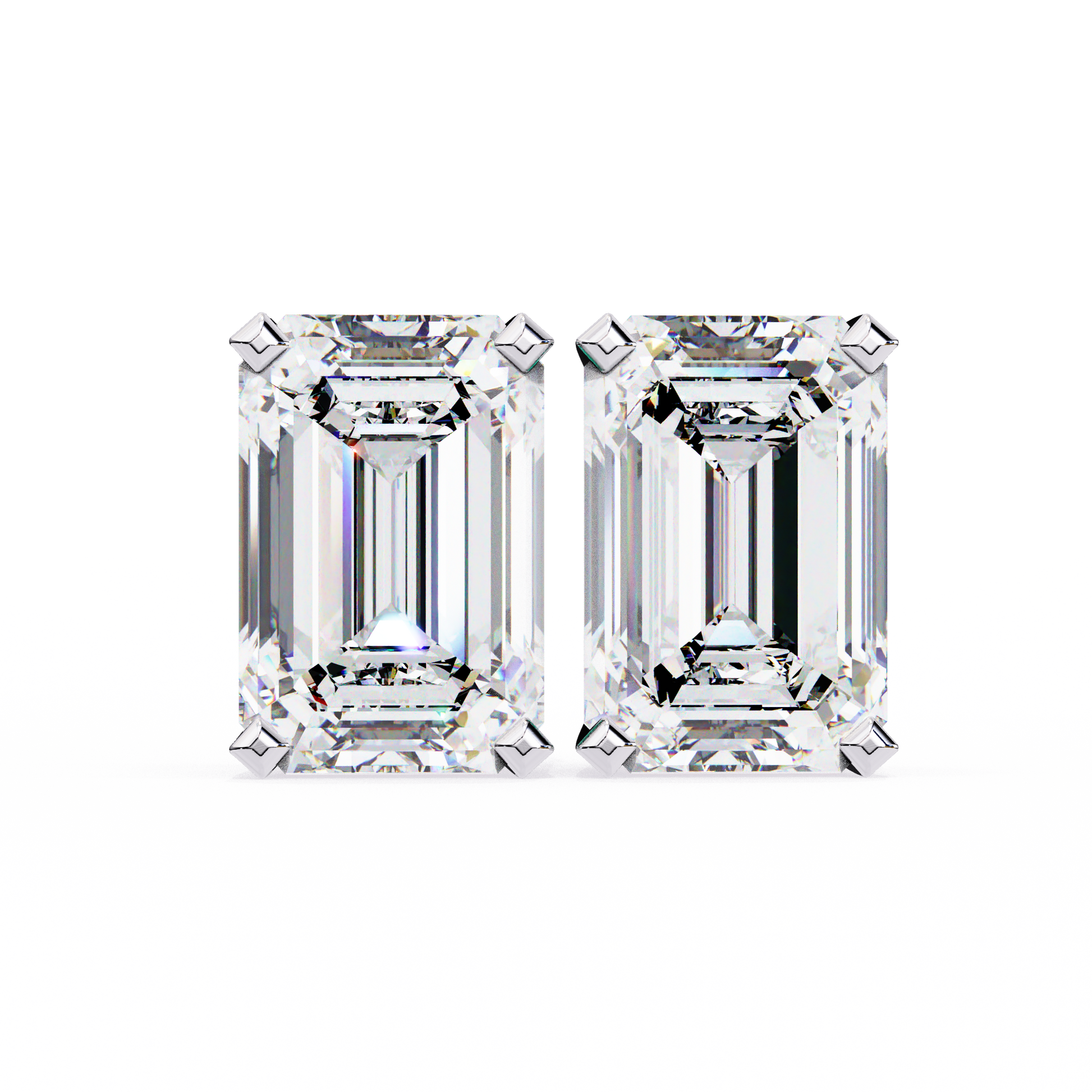 Two emerald-cut diamonds on a white background