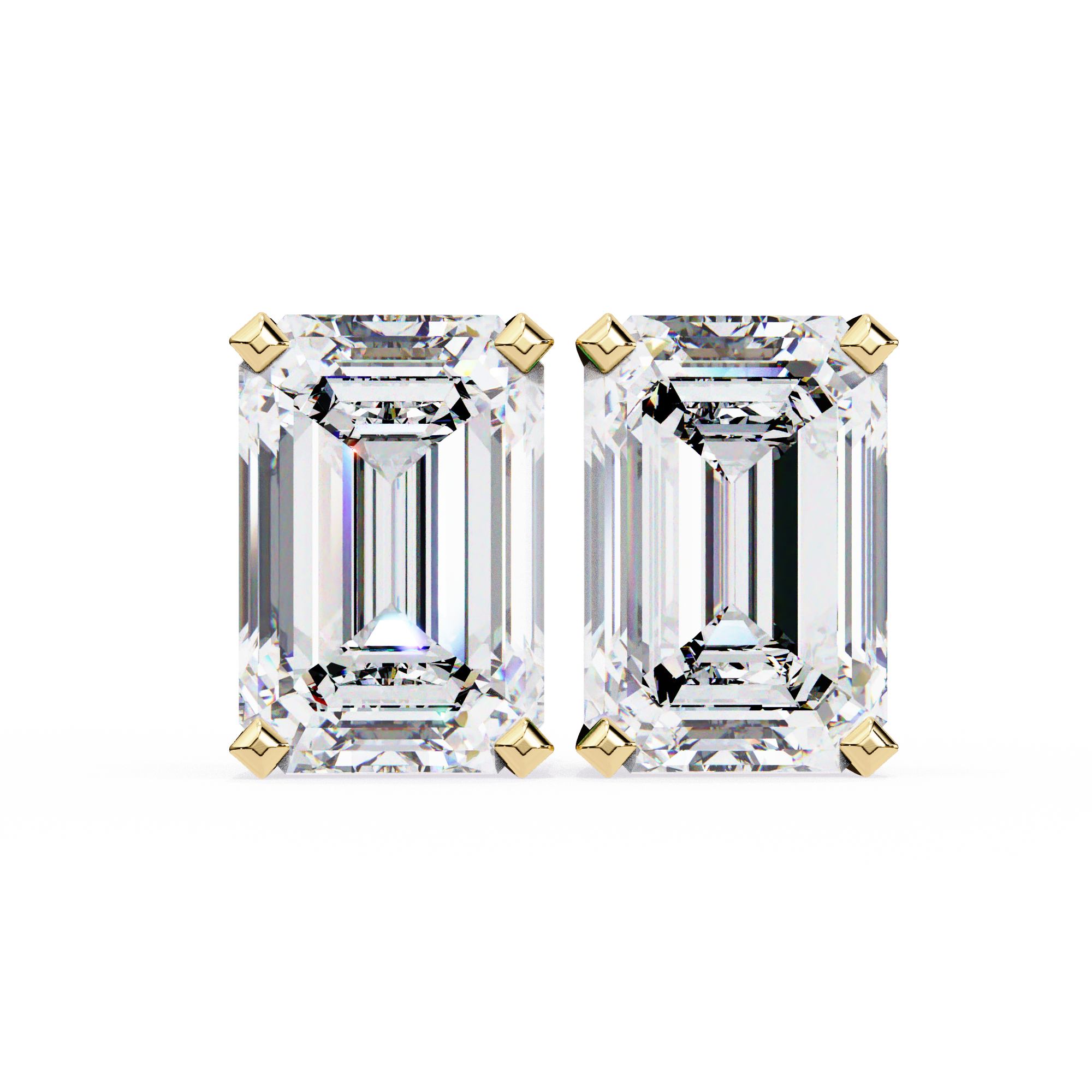 Pair of emerald-cut diamonds with gold prongs on a white background