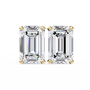 Pair of emerald-cut diamonds with gold prongs on a white background