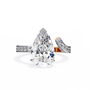 features a breathtaking Pear centre that appears to hover above the finger, supported by a unique detached double-band design