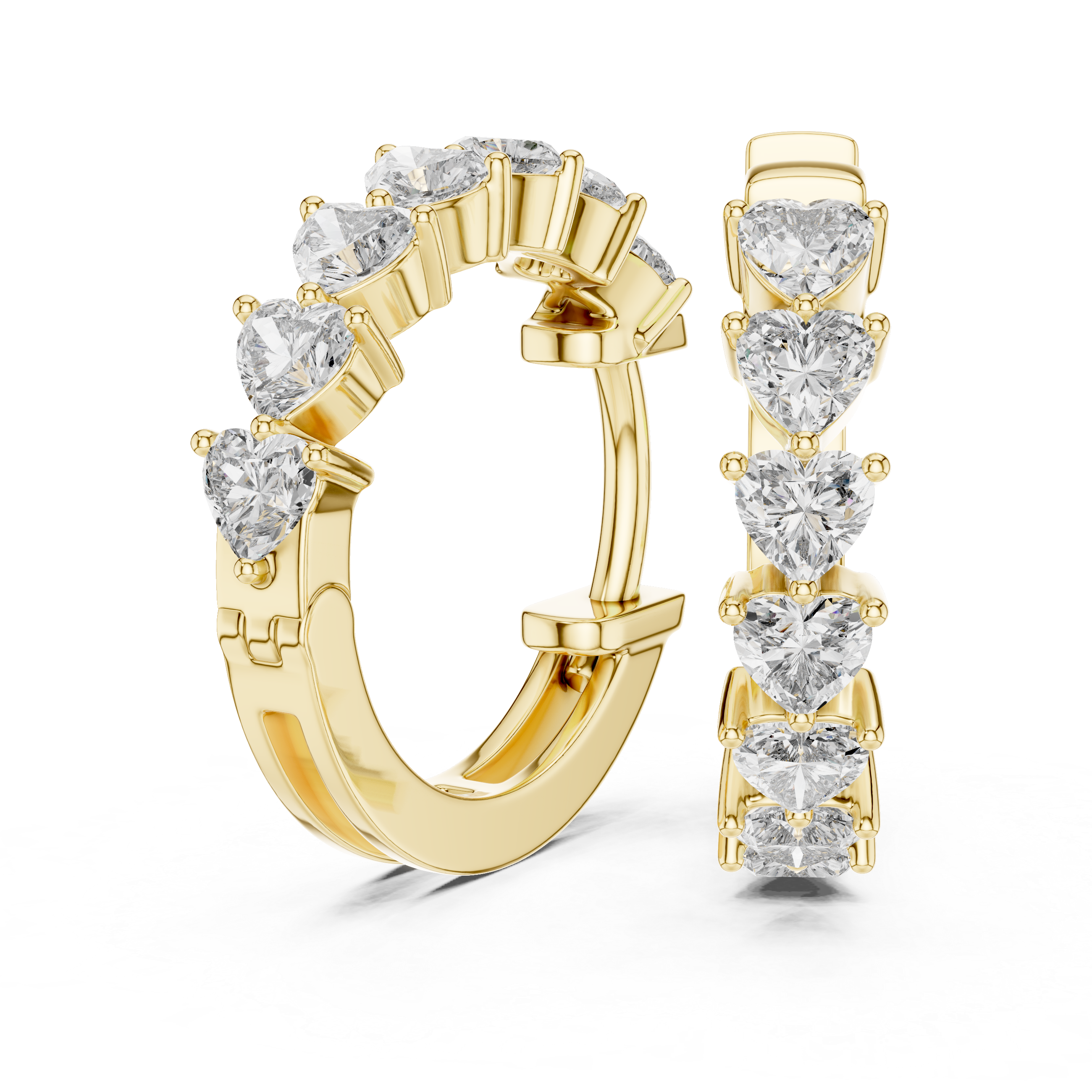 Pair of gold hoop earrings with heart-shaped diamonds on a white background
