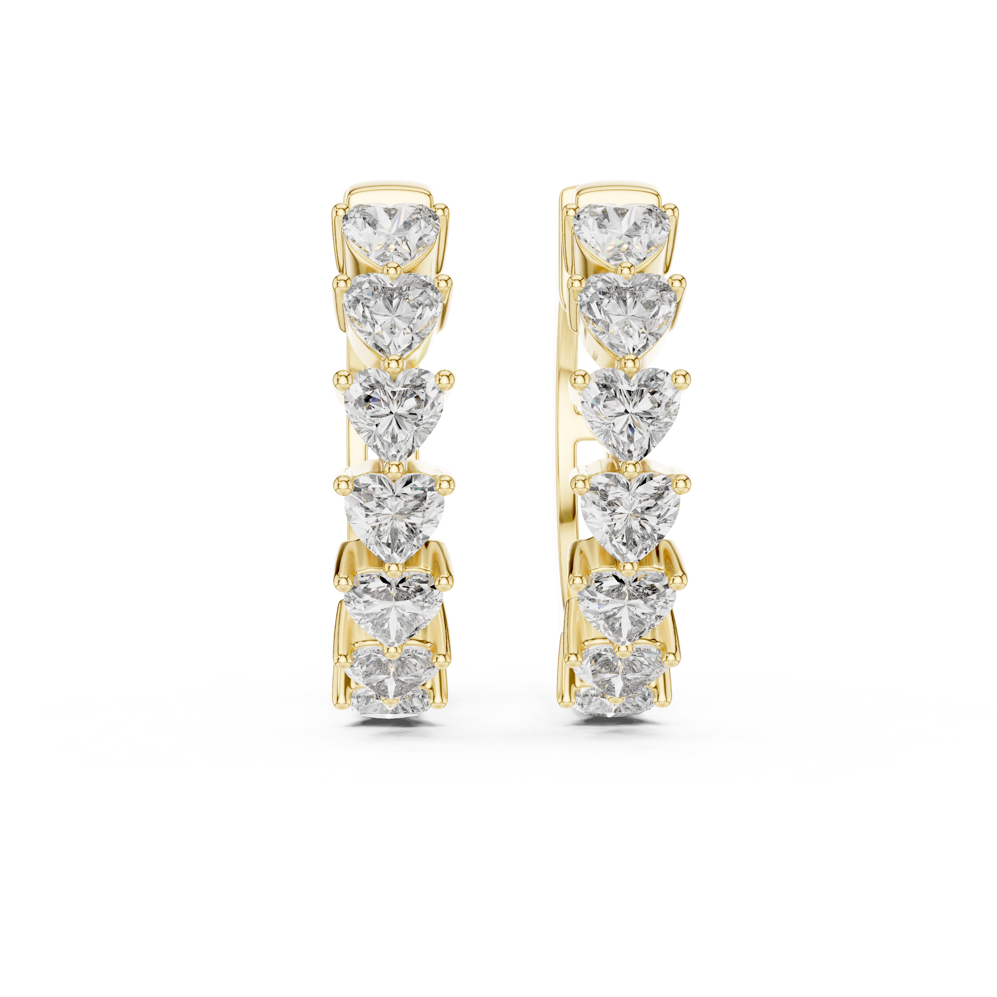 Pair of gold hoop earrings with heart-shaped diamonds on a white background
