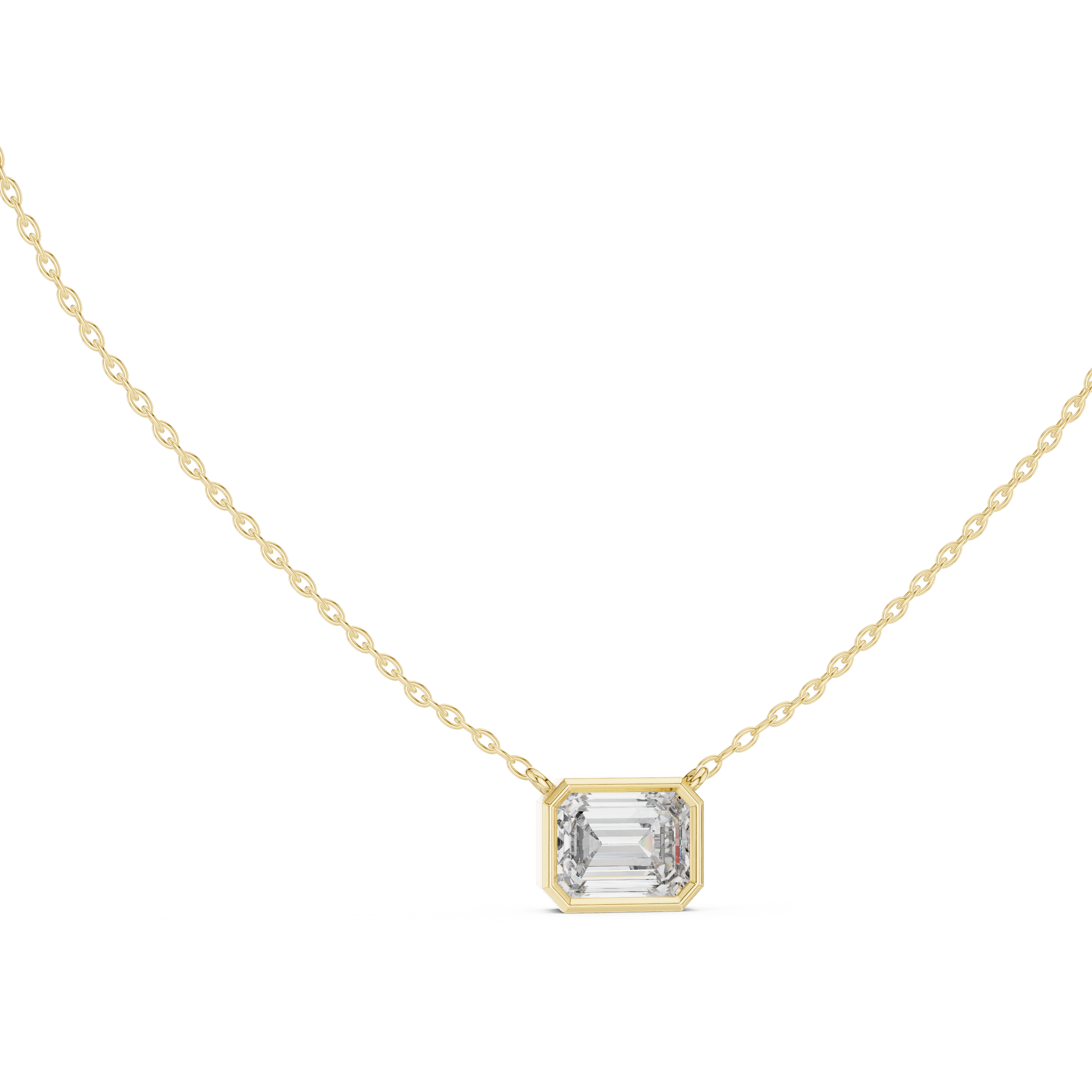 Gold necklace with a emerald pendant on a white background