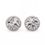 Pair of round diamond stud earrings on a white background