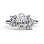 ring features an Oval Diamond centre flanked by a delicate cluster of shimmering round diamonds on either side