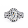ring showcases a spectacular Oval Diamond encircled by a shimmering halo