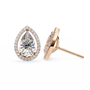 Teardrop-shaped diamond earrings with rose gold setting on a white background