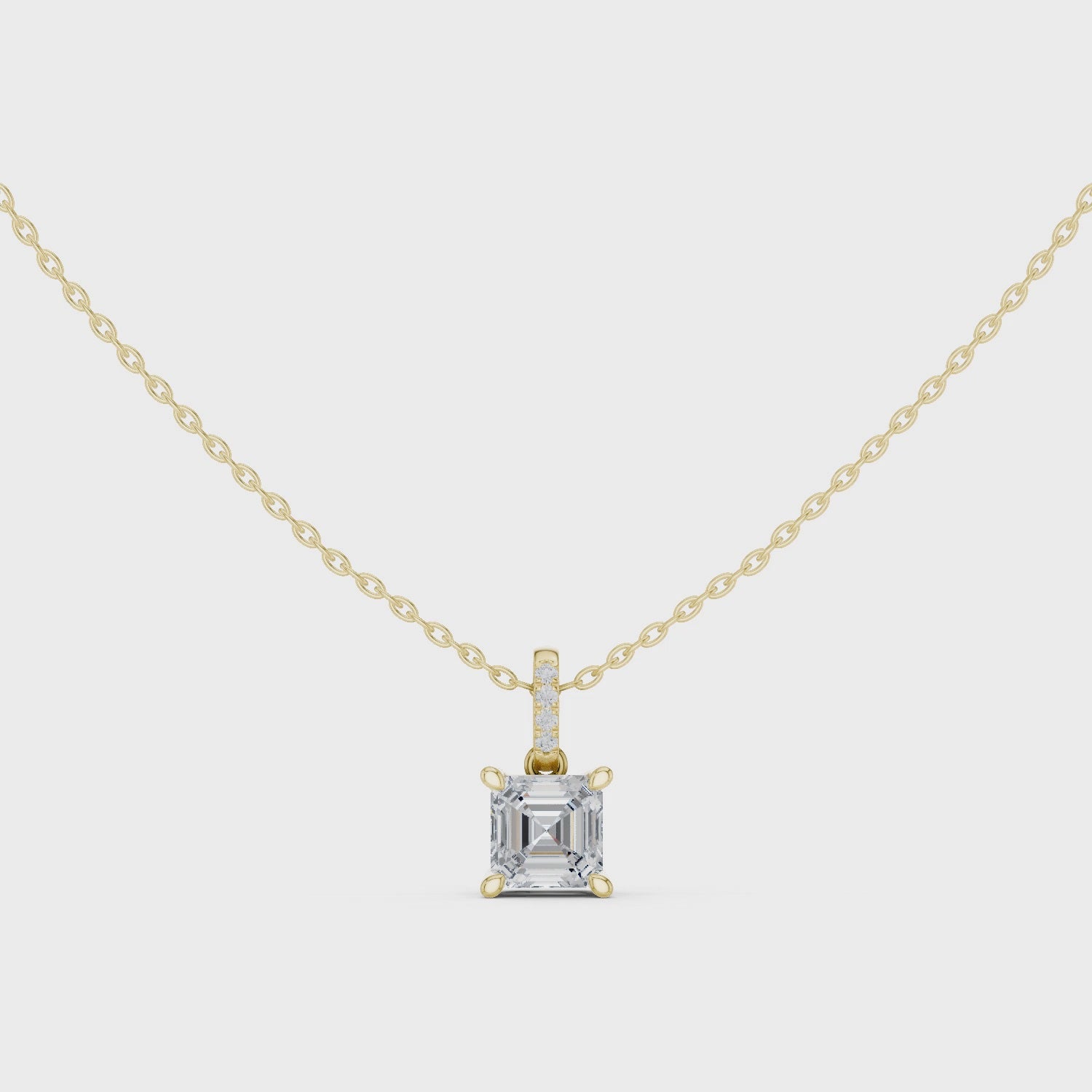 Gold pendant necklace with a diamond on a white background