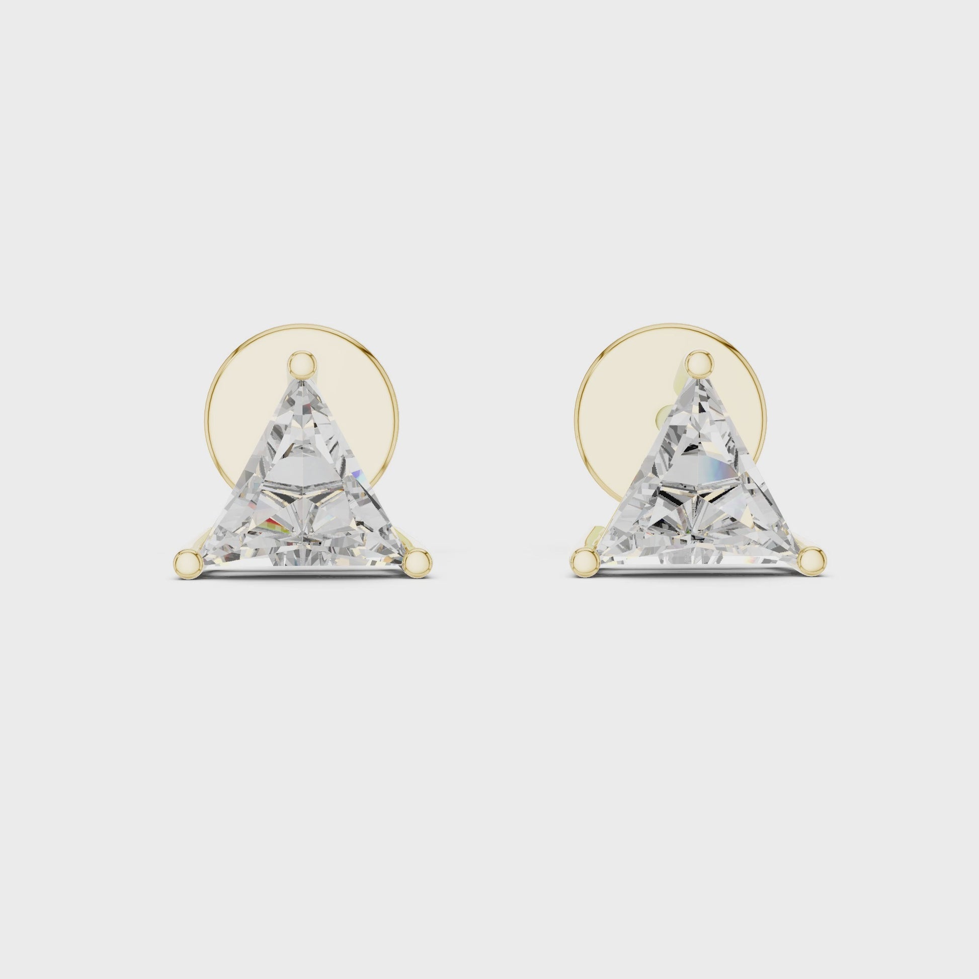 Pair of triangle-shaped diamond earrings with gold posts on a white background
