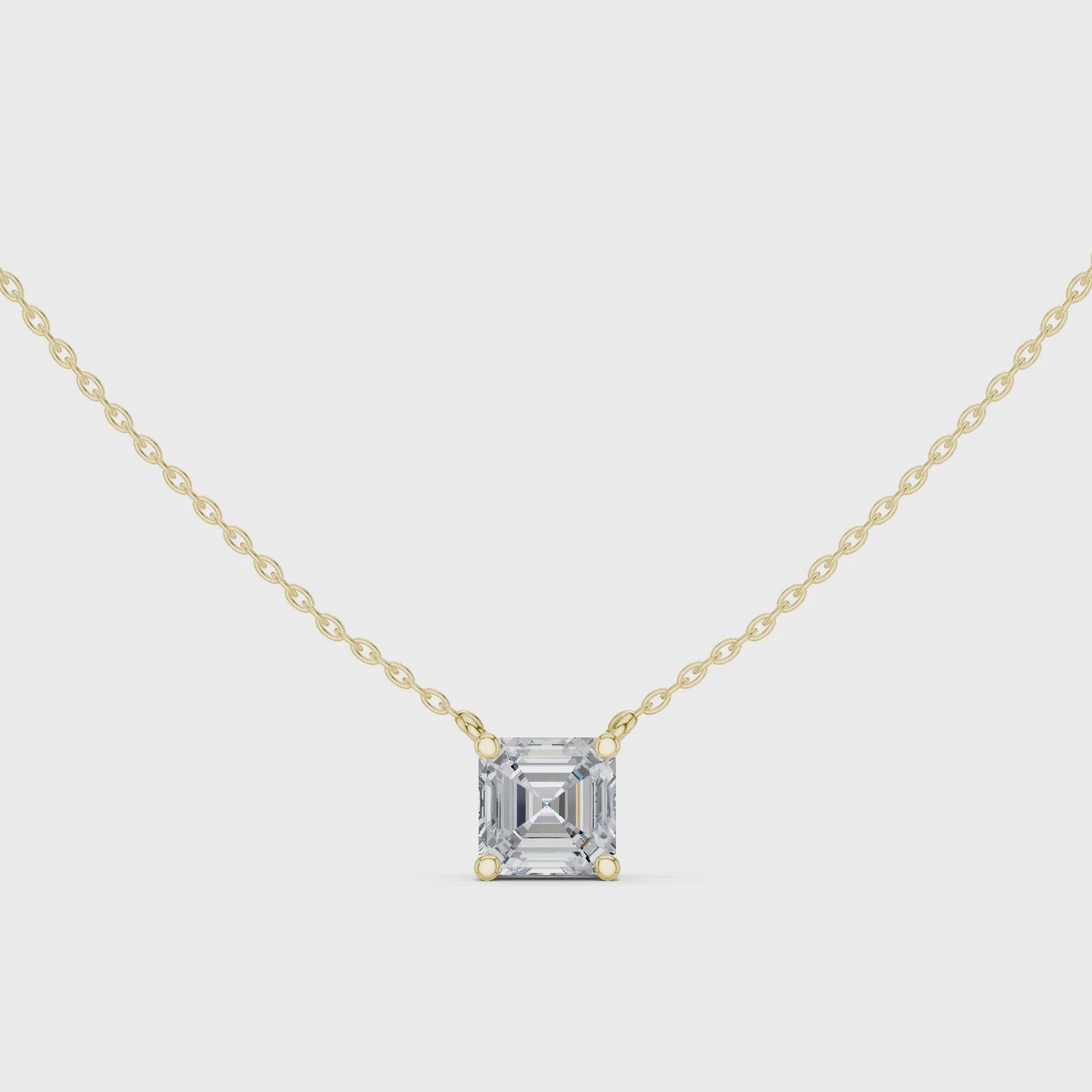 Gold necklace with a Asscher-cut diamond pendant on a white background
