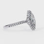 ring features a brilliant Marquise-cut solitaire encircled by a seamless halo of shimmering diamonds