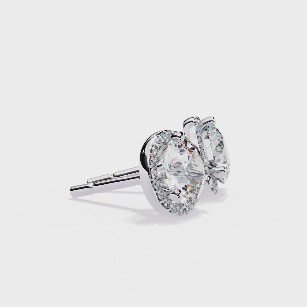 Pair of round diamond stud earrings on a white background