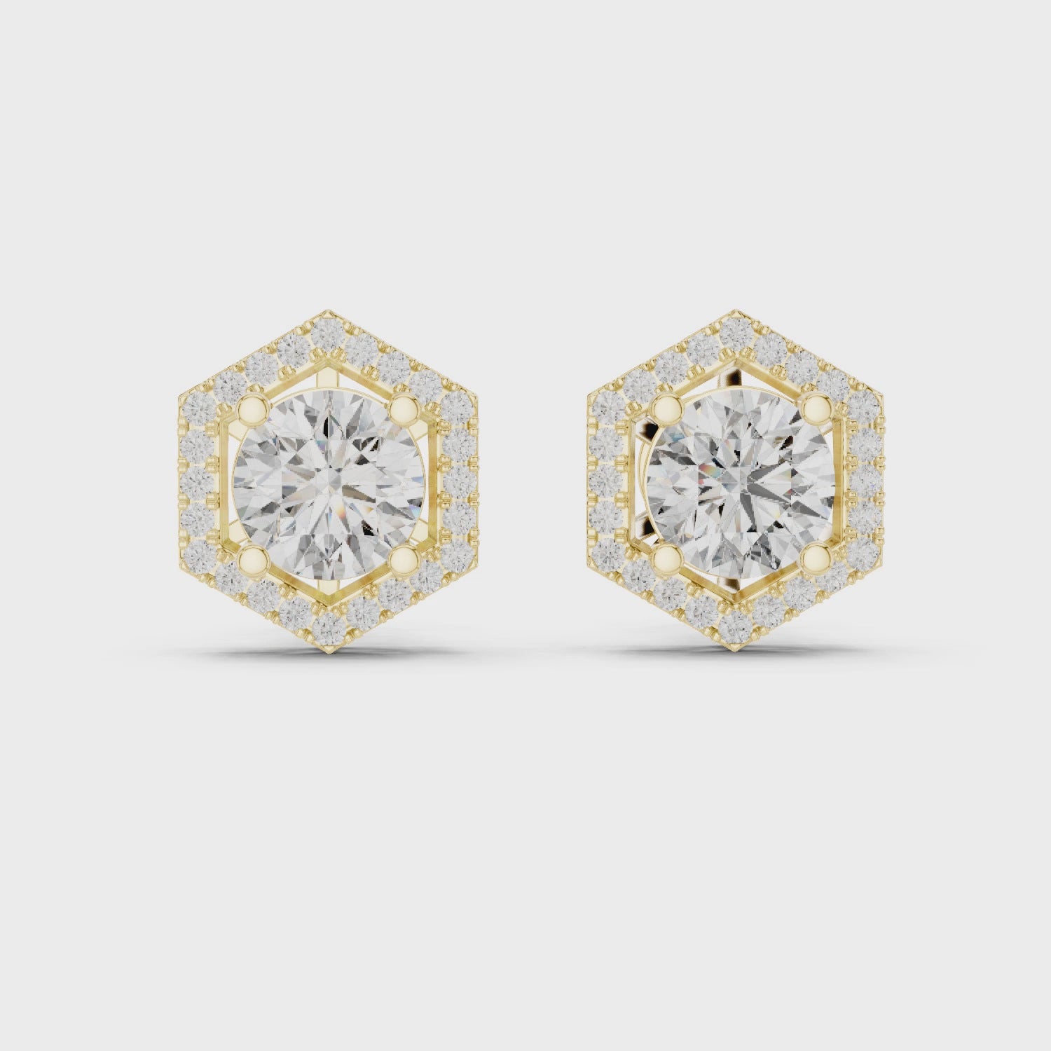 Hexagonal diamond earrings with gold accents on a white background