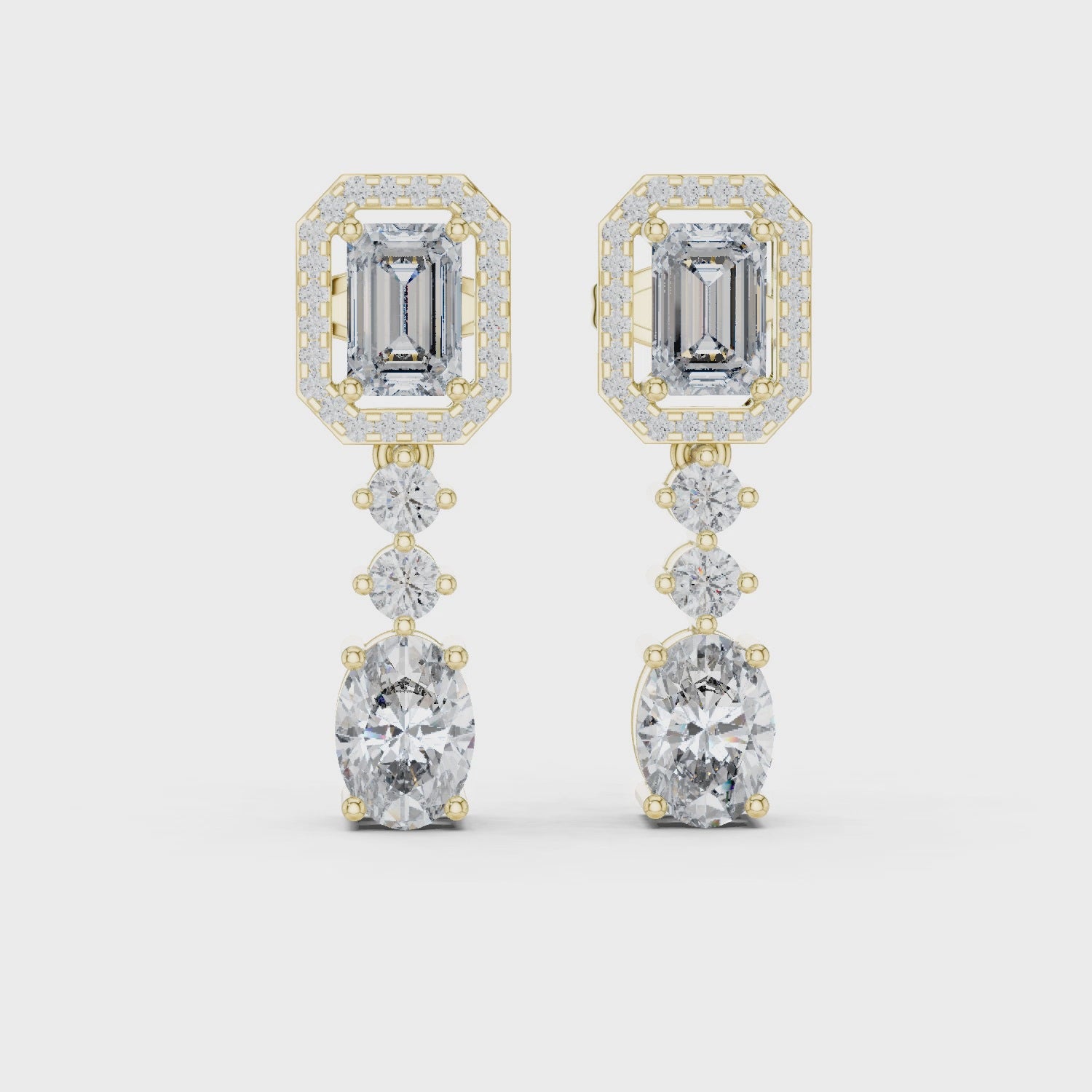 Gold earrings with diamonds on a white background