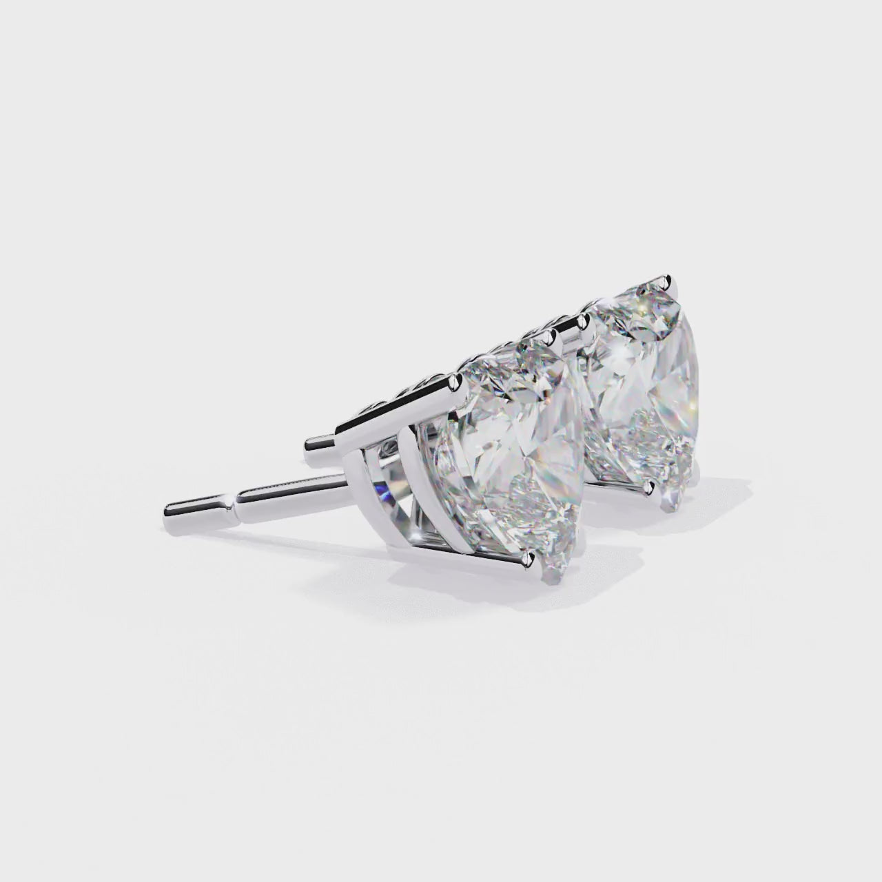 Heart-shaped diamond earrings on a white background