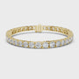 Gold bracelet with diamond accents on a white background
