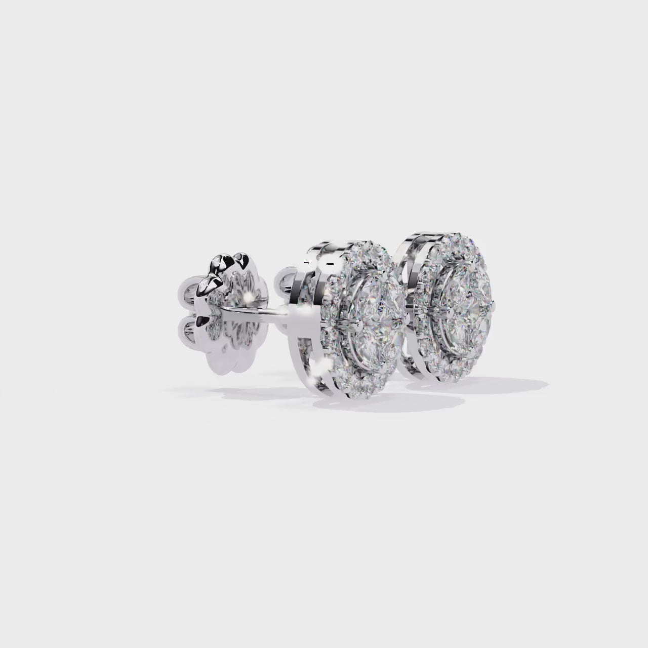 Pair of diamond earrings with gold accents on a white background