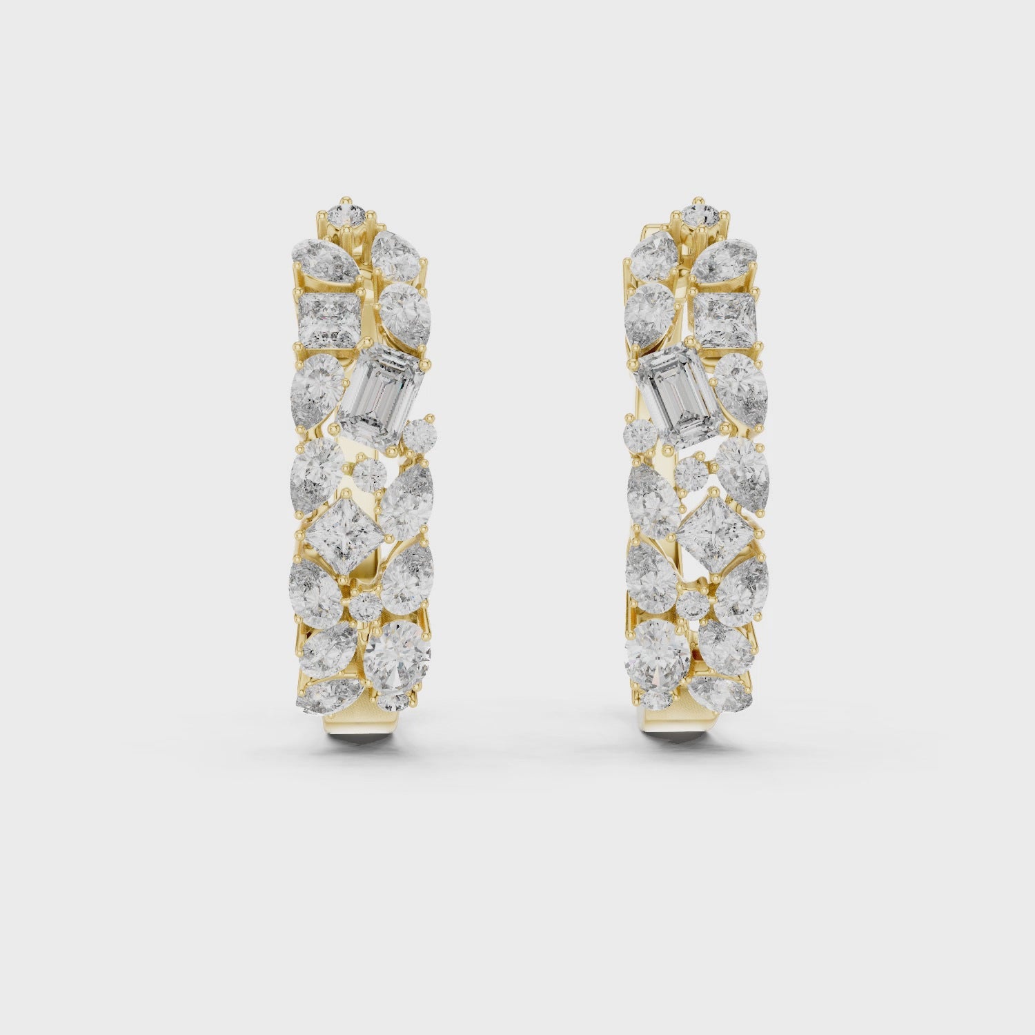 Pair of diamond earrings with gold and silver accents on a white background