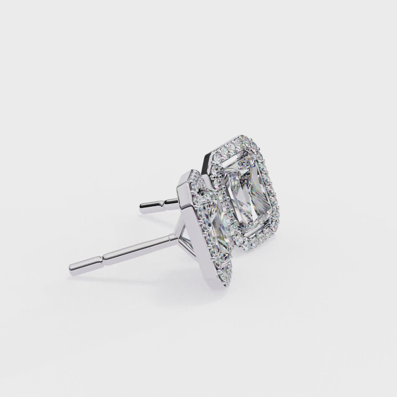 Pair of diamond earrings with white gold frames on a white background