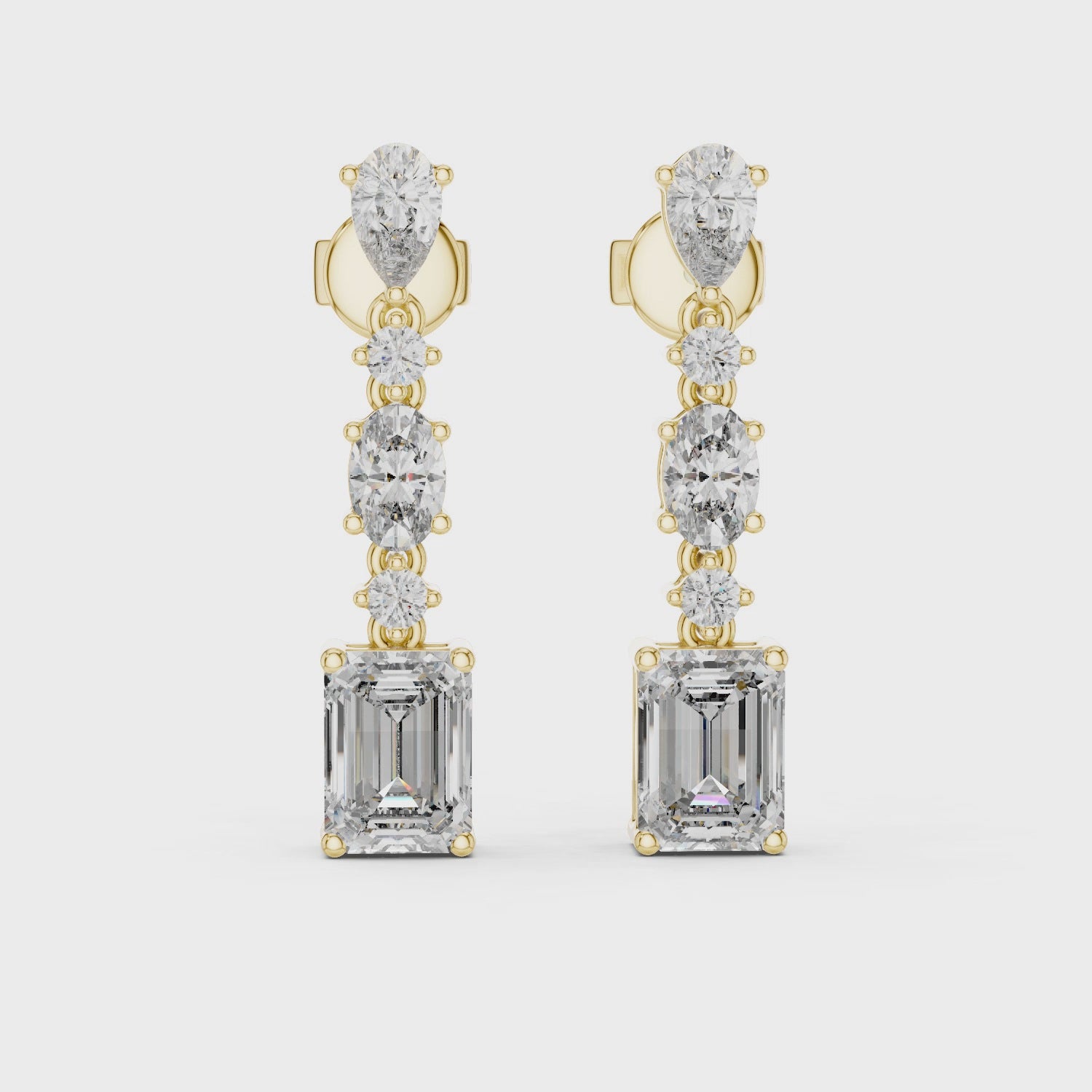 Gold and diamond earrings on a white background