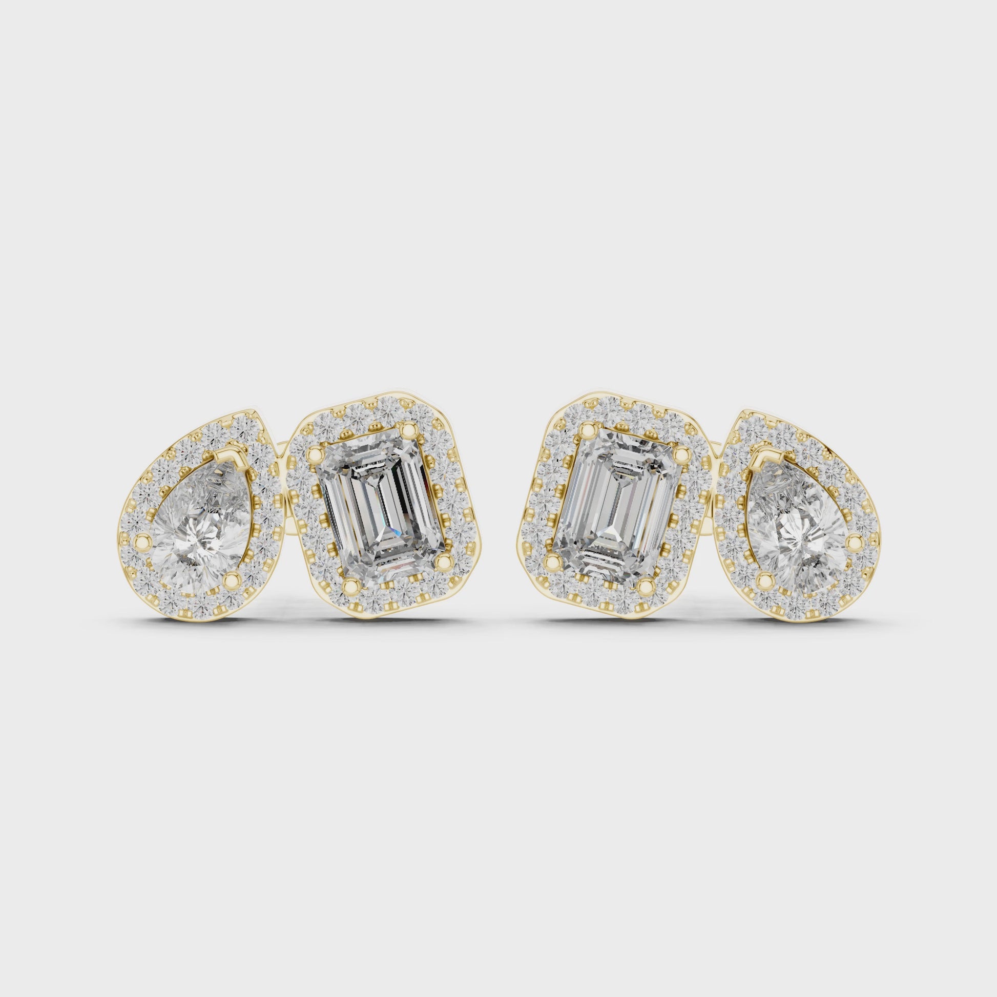 Pair of diamond earrings with emerald-cut stones on a white background