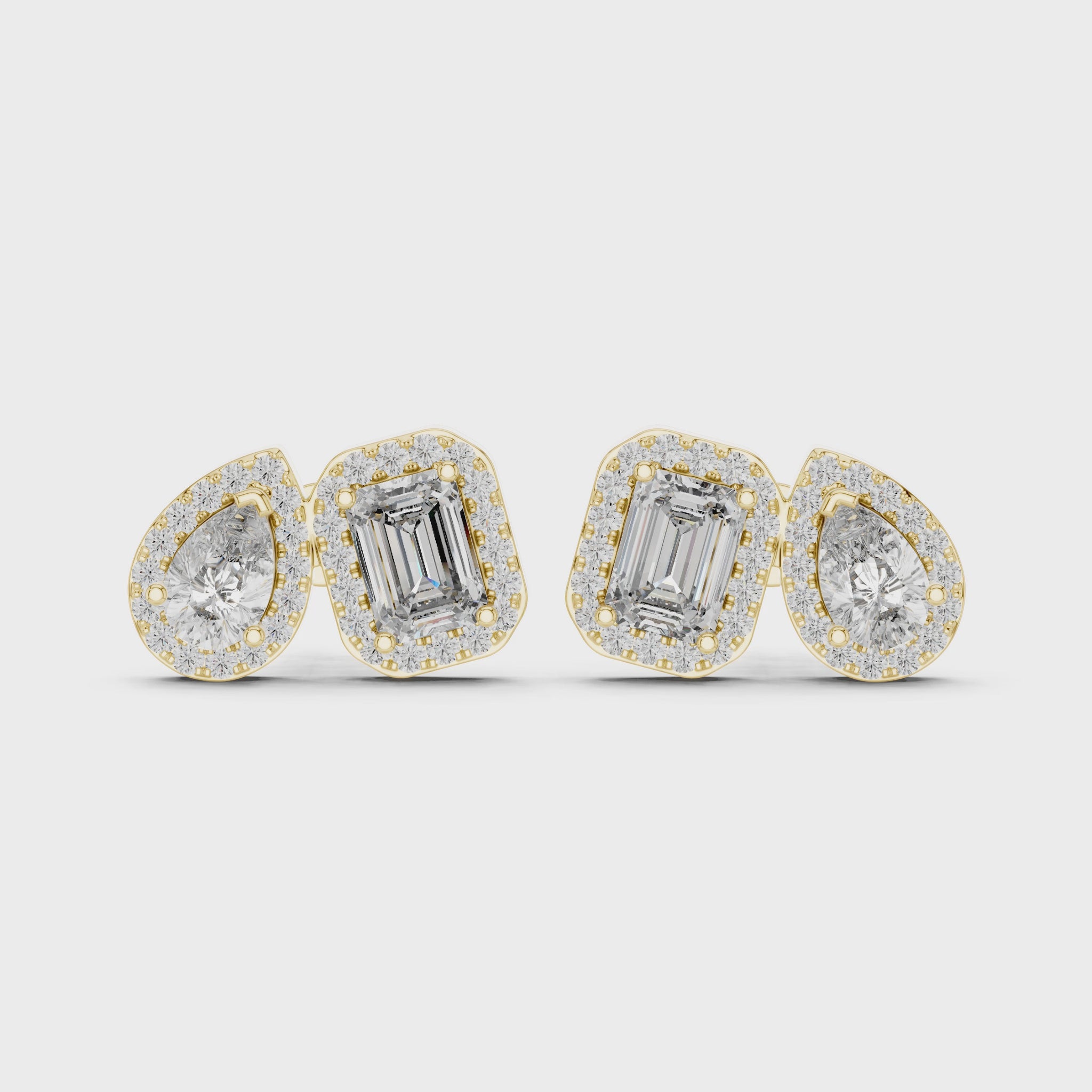 Pair of diamond earrings with emerald-cut stones on a white background