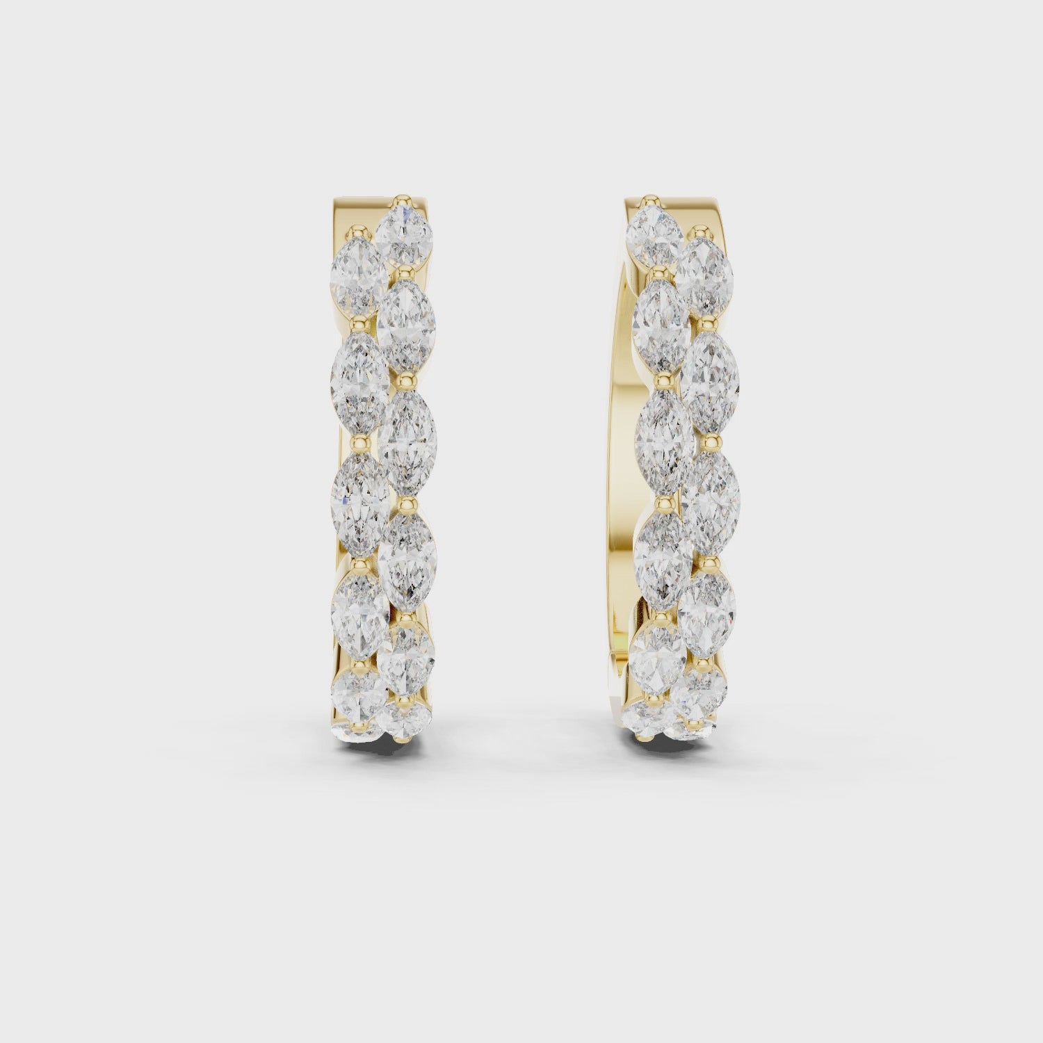 Gold hoop earrings with diamonds on a white background