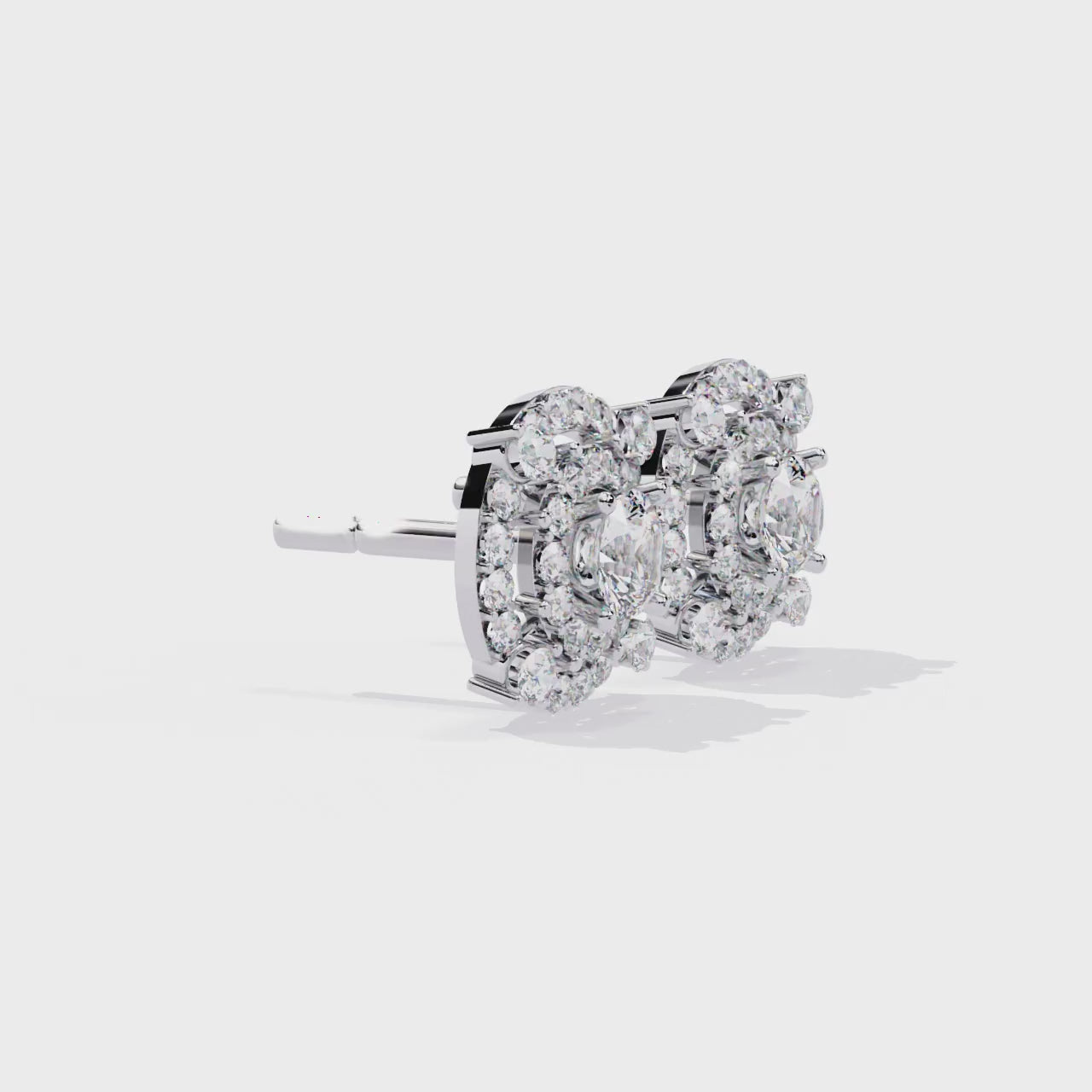 Pair of gold and diamond earrings on a white background