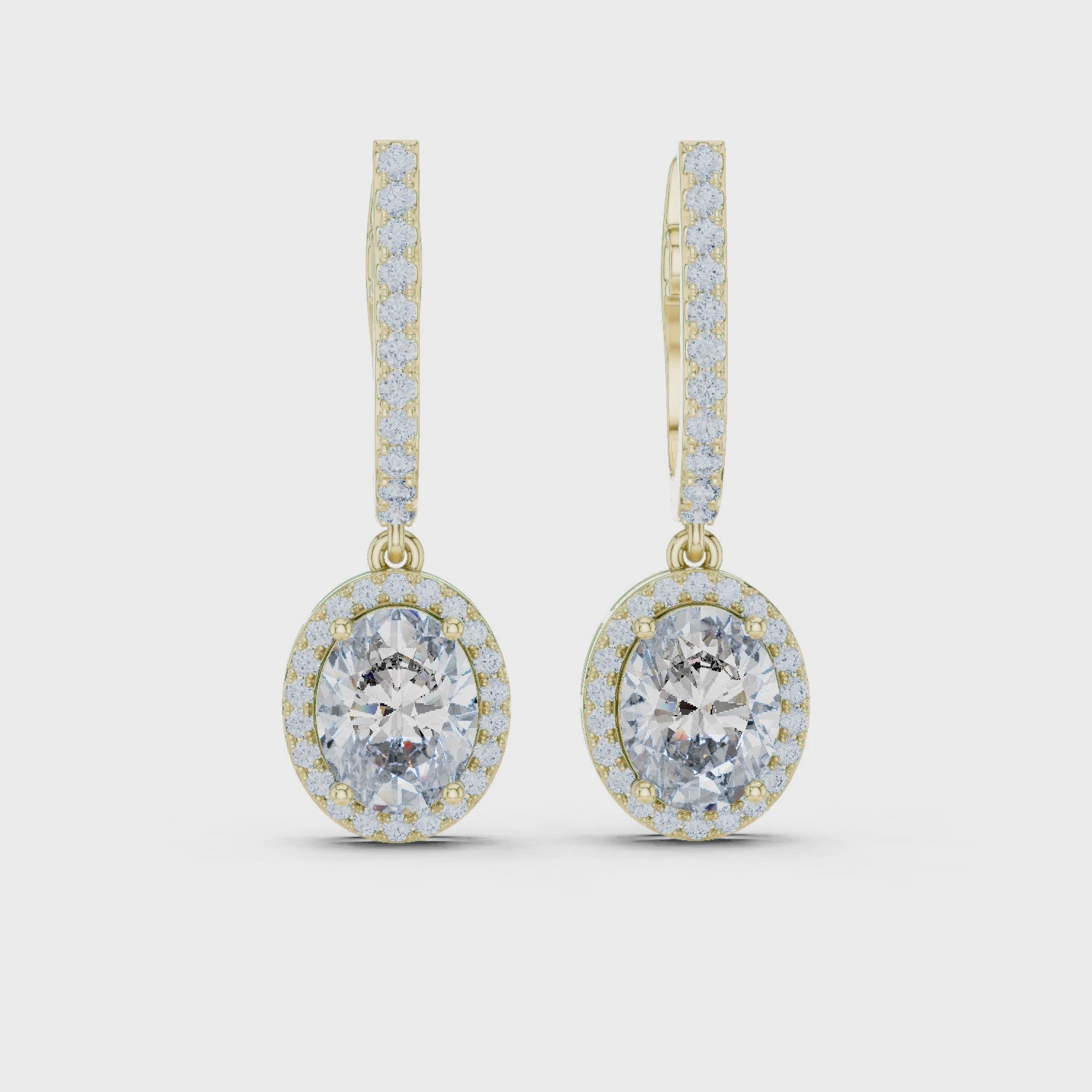 Gold earrings with diamonds on a white background