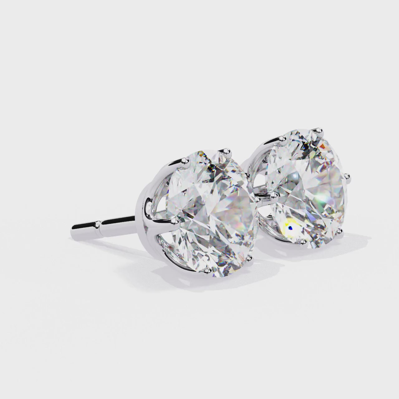 Pair of diamond stud earrings on a white background