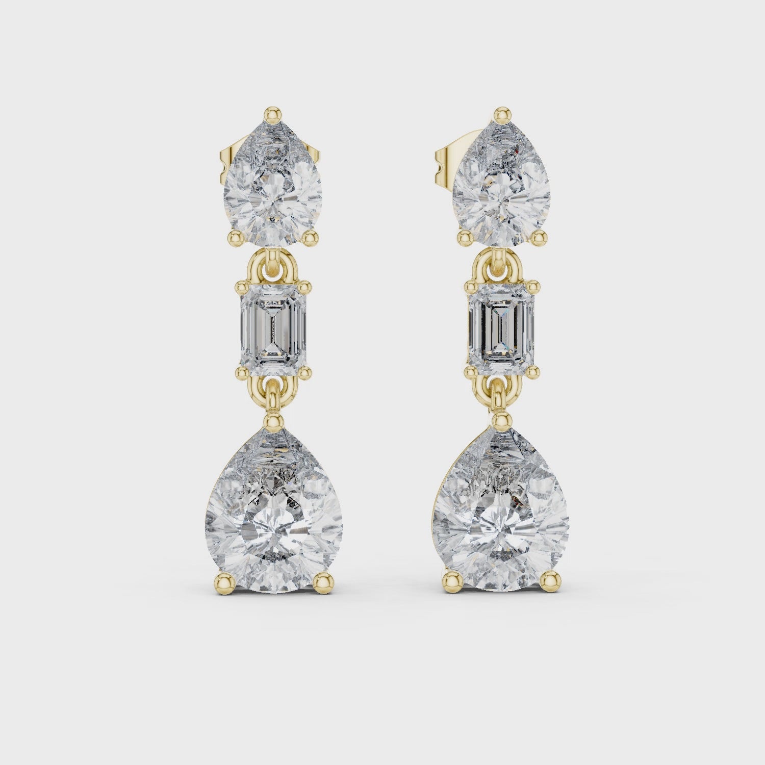 Gold and diamond earrings on a white background