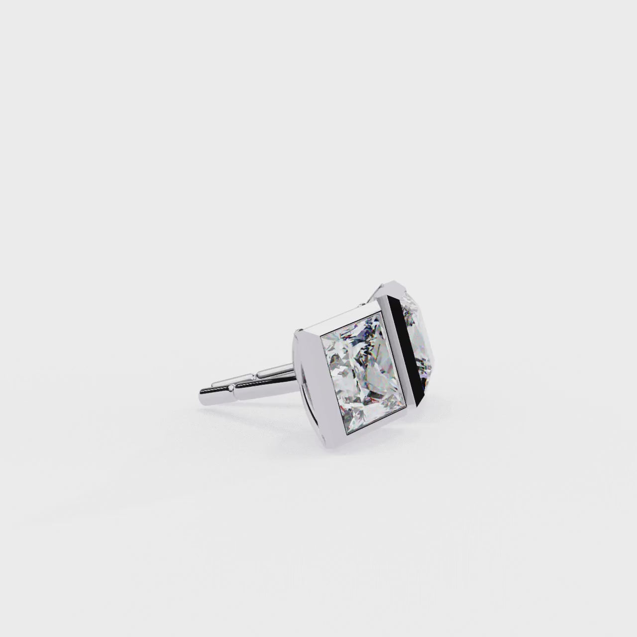 Pair of diamond stud earrings with gold prongs on a white background