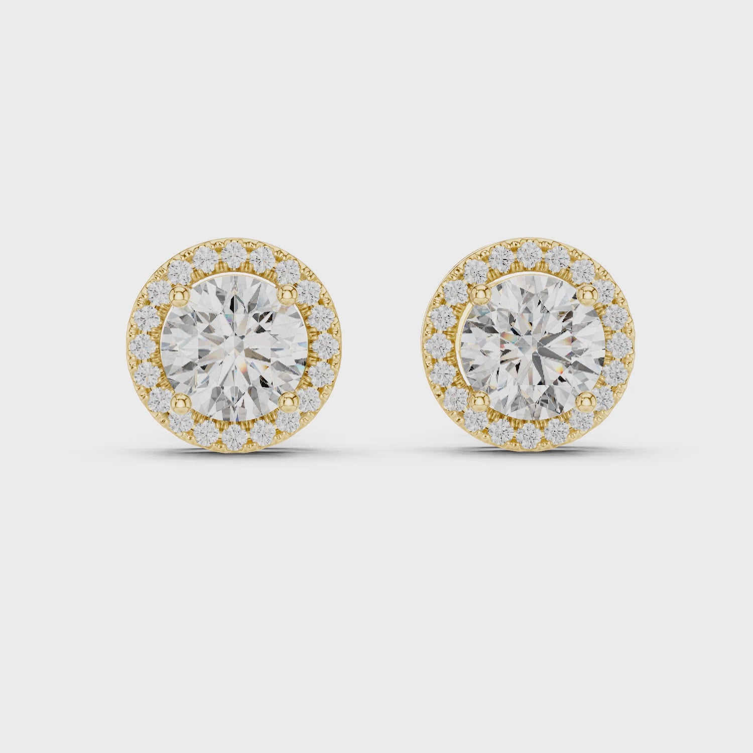 Pair of diamond earrings with gold accents on a white background