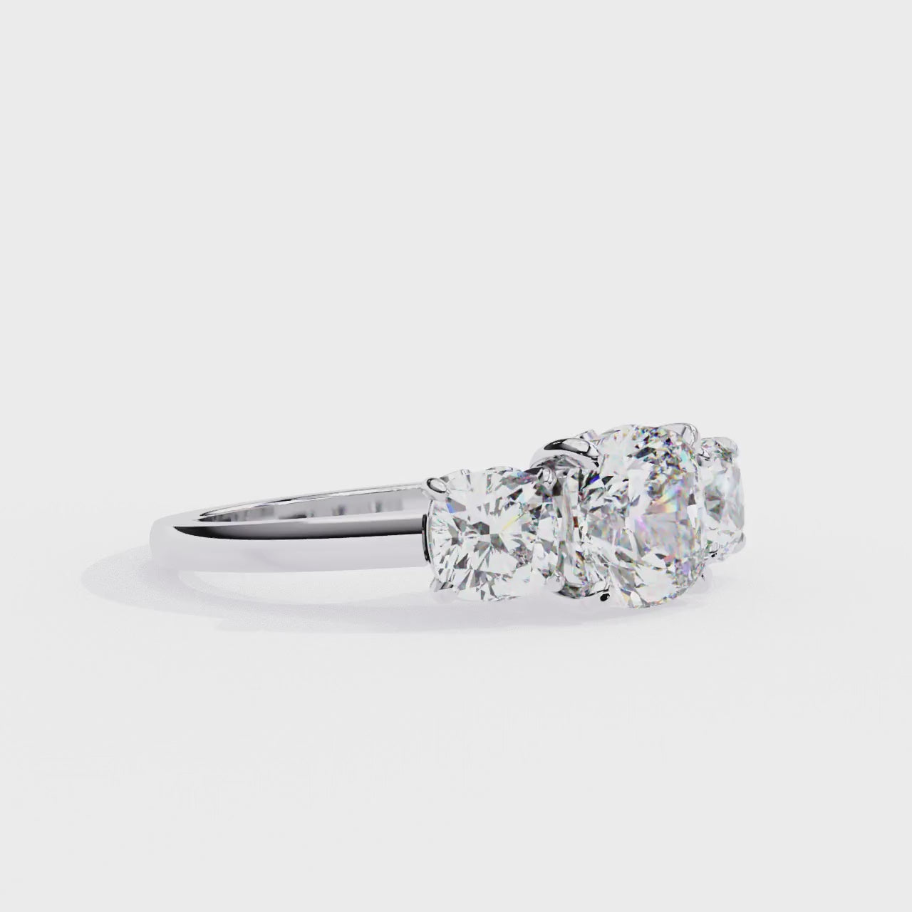 Cushion-cut solitaire flanked by two perfectly matched cushion-cut side stones