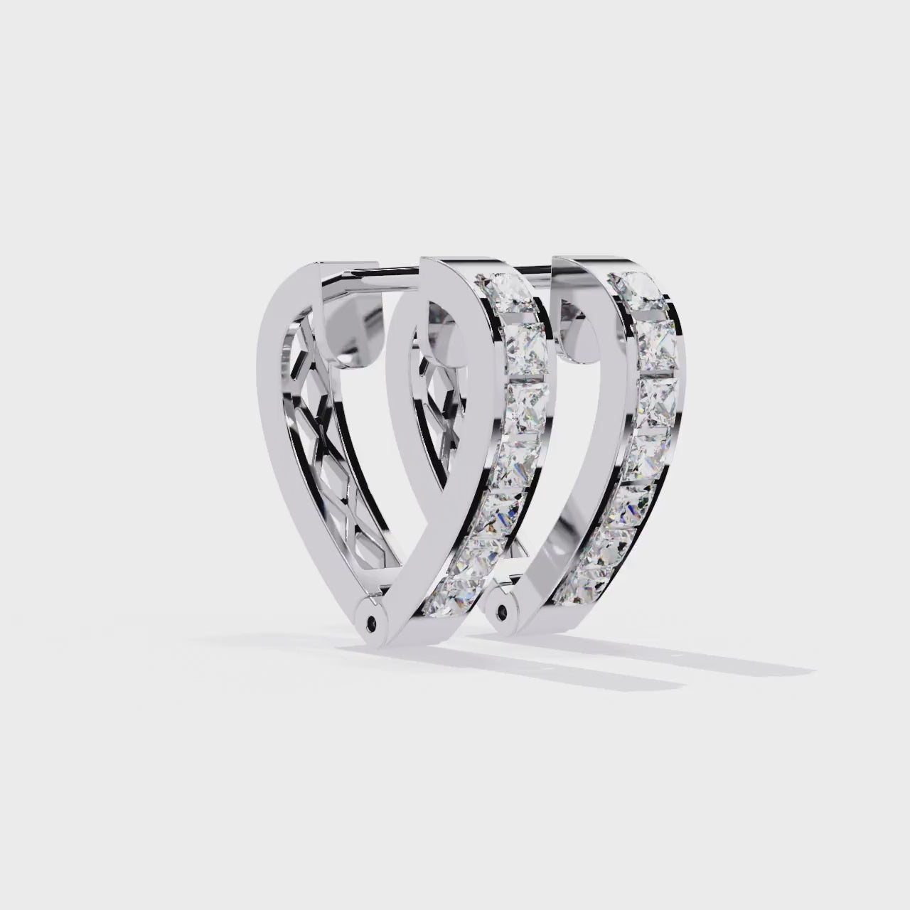 Silver hoop earrings with embedded diamonds on a white background