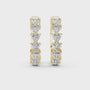 Pair of gold hoop earrings with heart-shaped diamonds on a white background