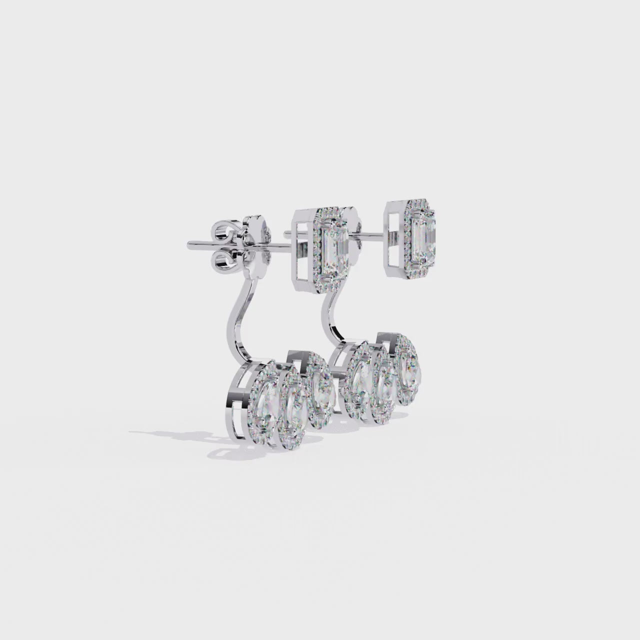 Pair of diamond earrings with gold and silver accents on a white background