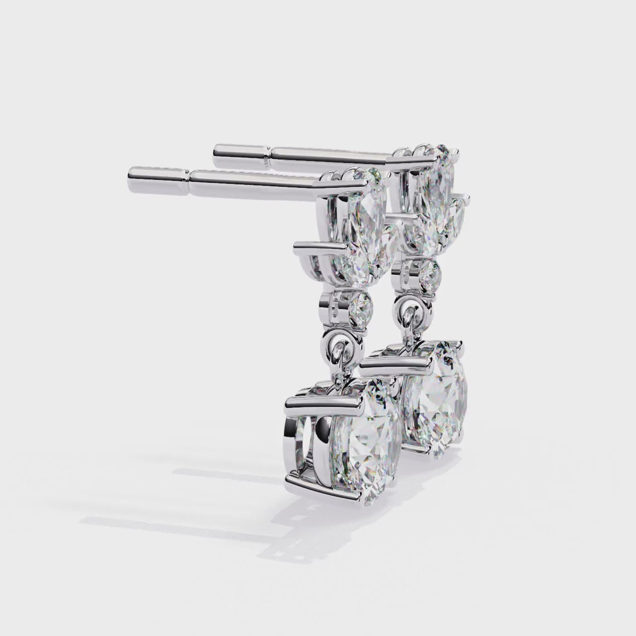 Pair of diamond earrings with gold accents on a white background